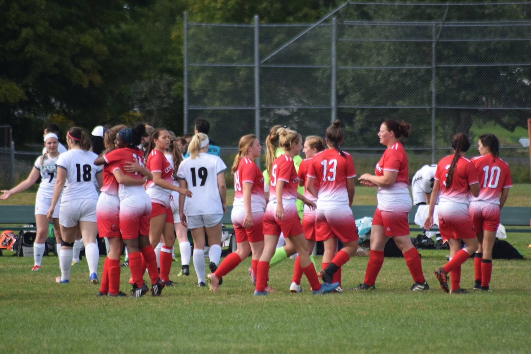 Women's Soccer celebrates after double-up VTC, 4-2.